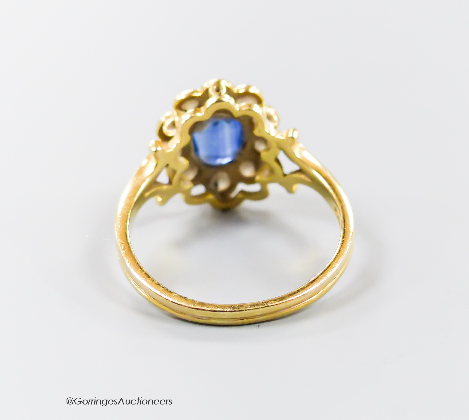 A modern 18ct gold, sapphire and diamond set oval cluster ring, size N, gross 3.8 grams.